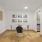 a room with a table chairs and a clock on the wall