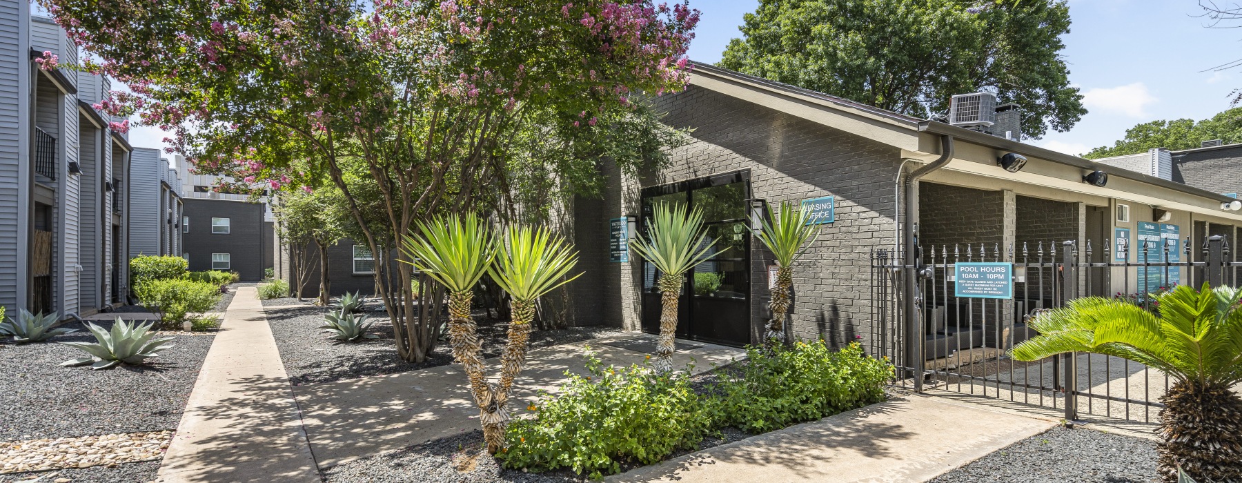 building with landscaping and a fence